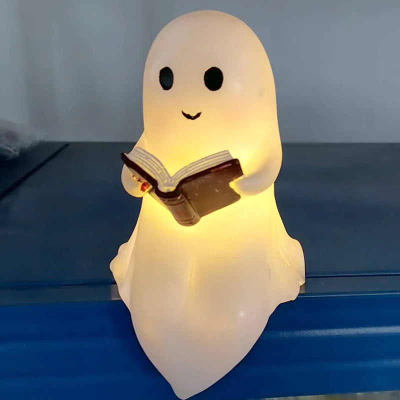 Cute ghost reading lamp glowing warmly